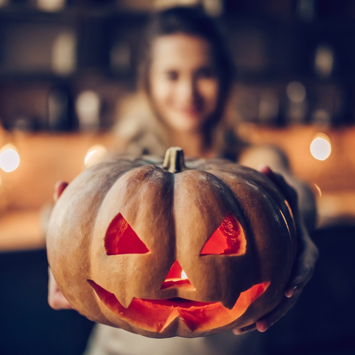 woman holding halloween pumpkin