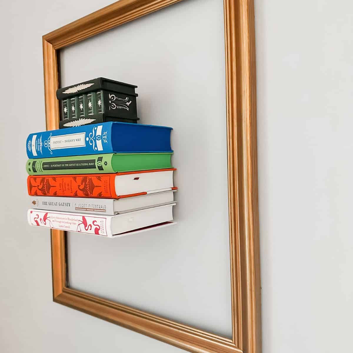 books on invisible floating bookshelf with a frame around them.