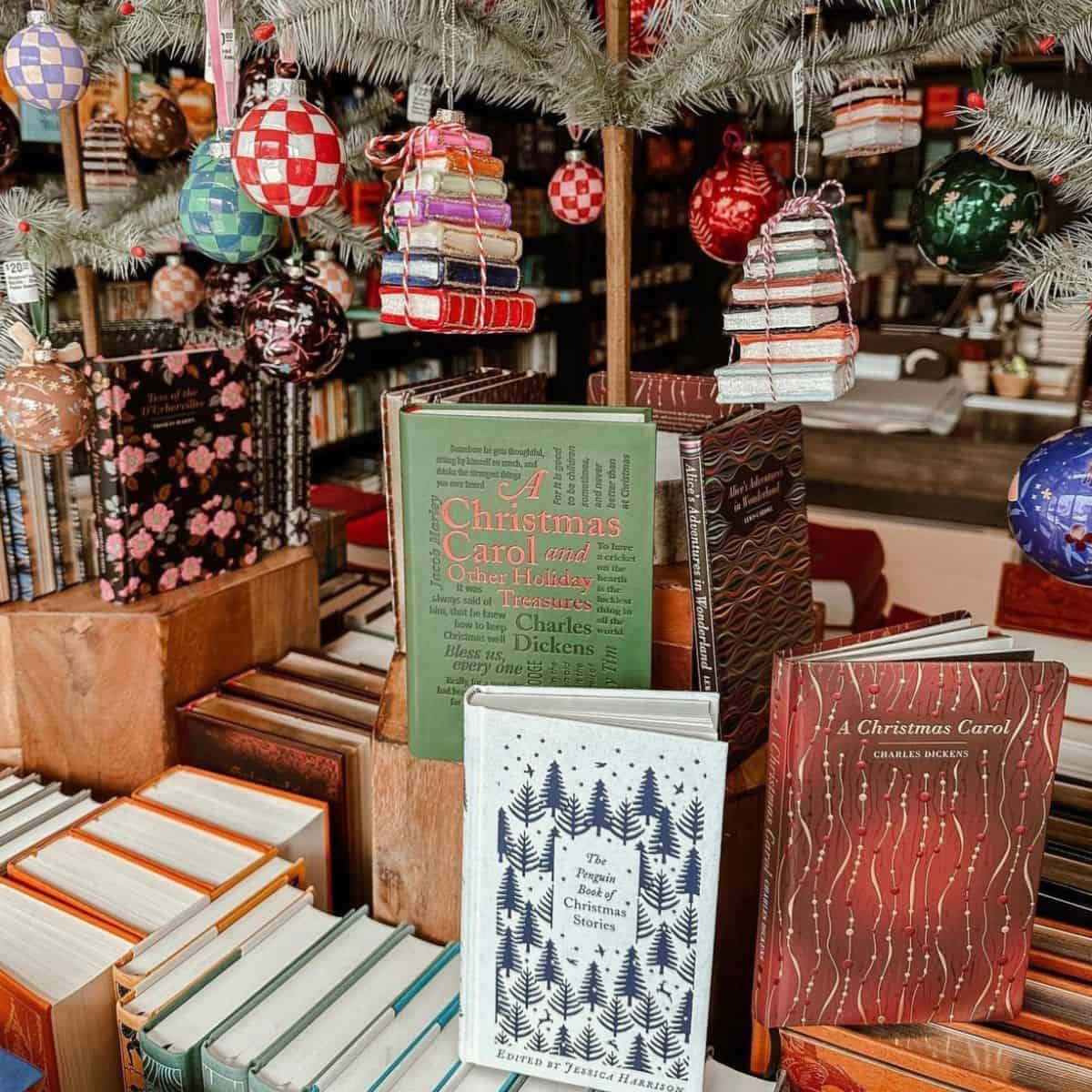 Christmas books in a bookstore with Christmas ornaments.