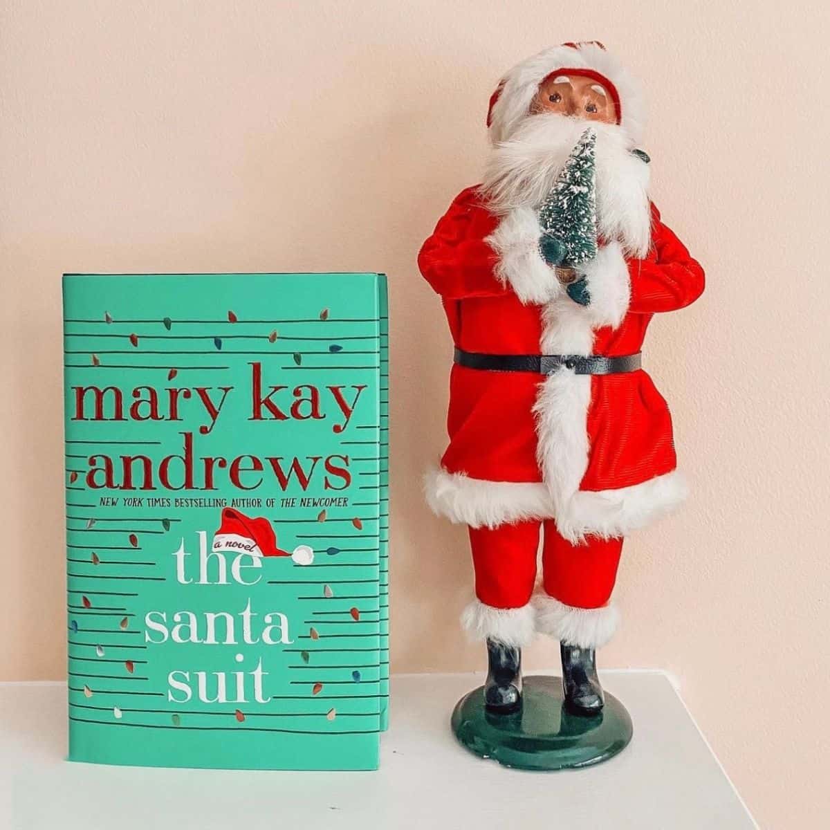 the santa suit by mary kay andrews with a santa doll.