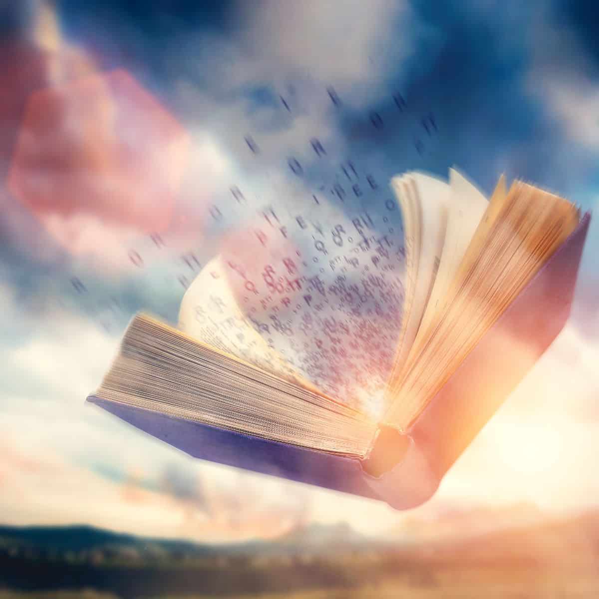 open book in front on clouds and light.