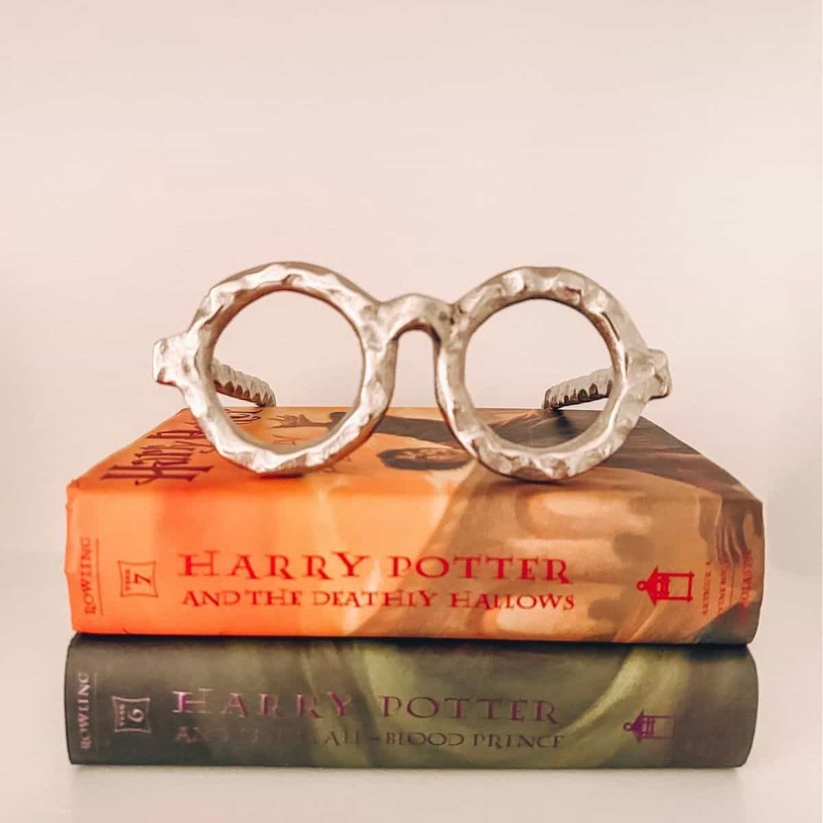 harry potter books with glasses on top of them.