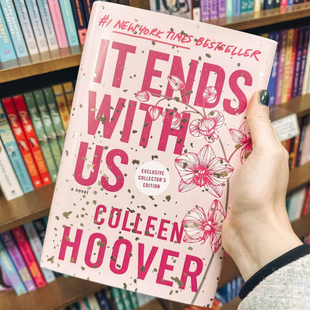 it ends with us by colleen hoover in front of bookshelves.