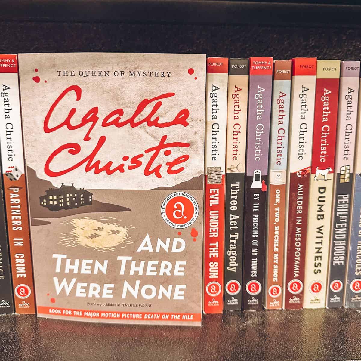 And then there were none by Agatha Christie and other Agatha Christie books on a bookshelf.