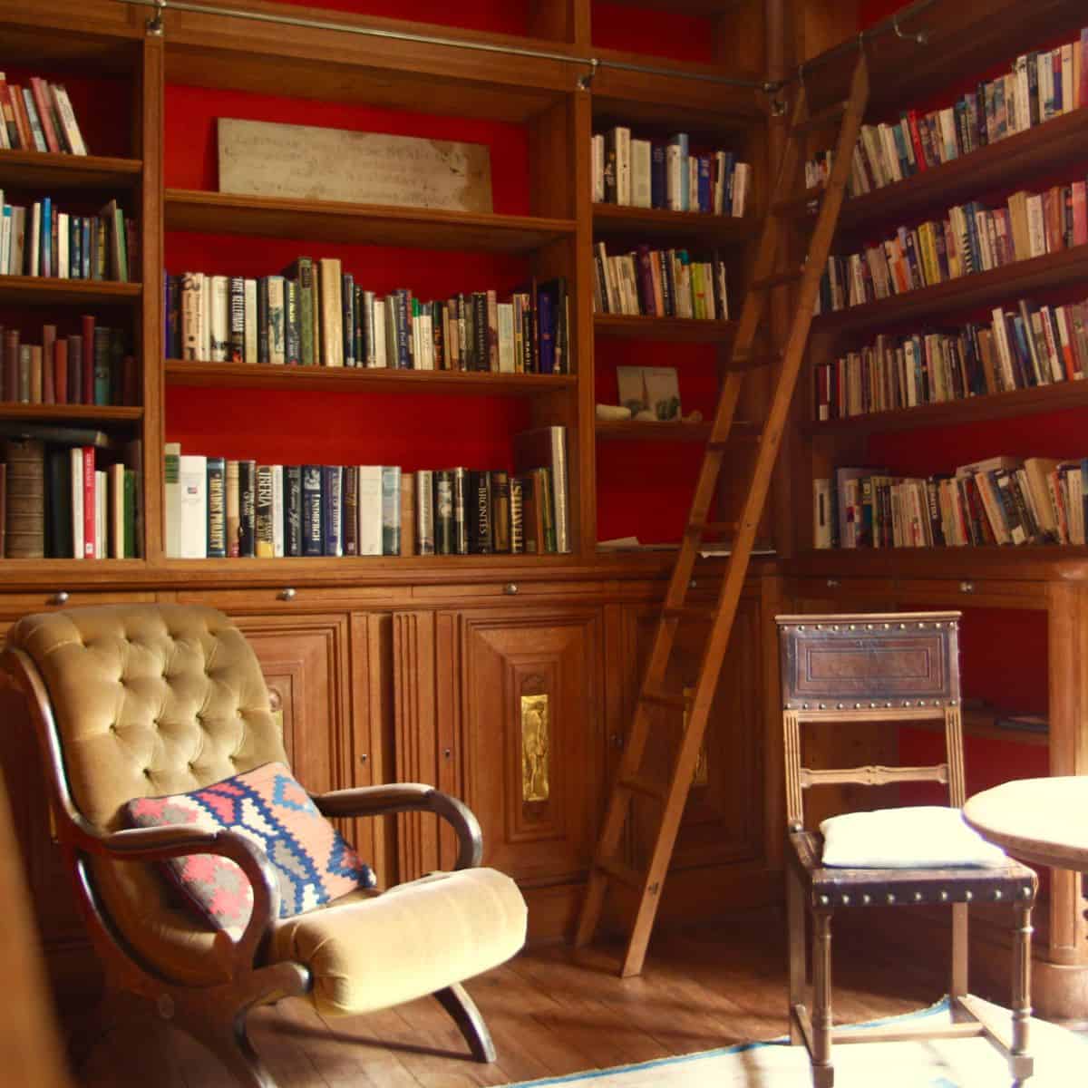 home library with ladder and chairs.