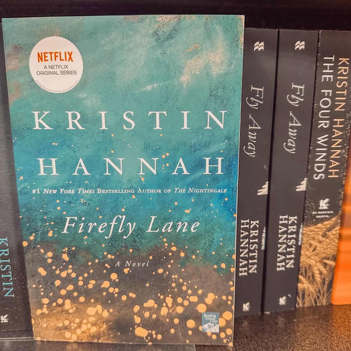 Firefly Lane and Fly Away by Kristin Hannah on a bookshelf.
