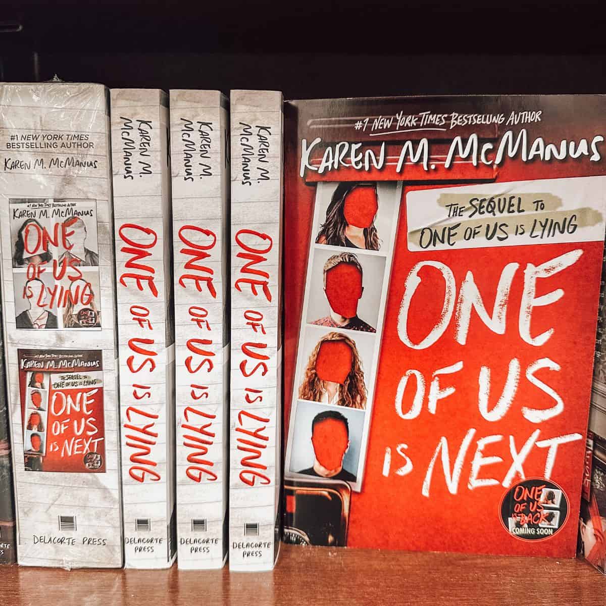One of us is lying series by Karen m. McManus on a bookshelf.