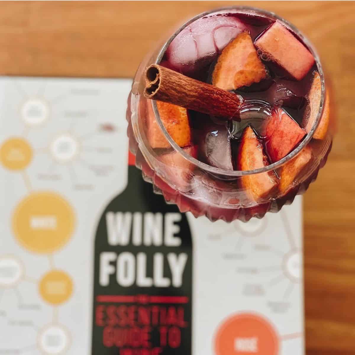 overhead view of red sangria in a glass with a wine book.